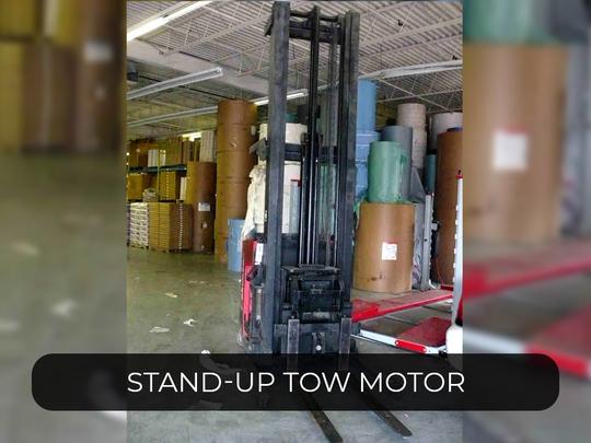 Stand-up Tow Motor ID# 1063